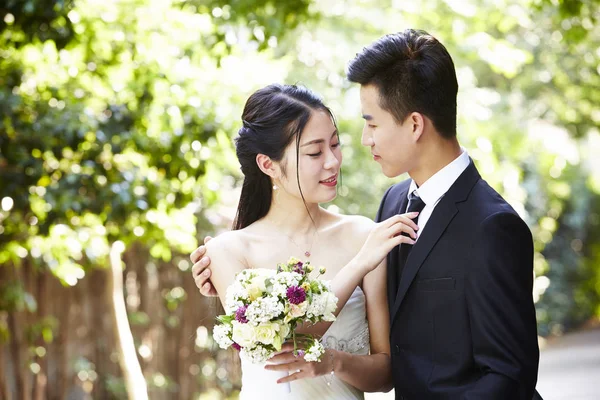 Outdoor portrait of a newly-wed asian couple — Stock Photo, Image