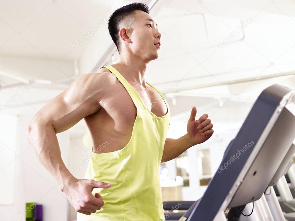 asian bodybuilder running on treadmill