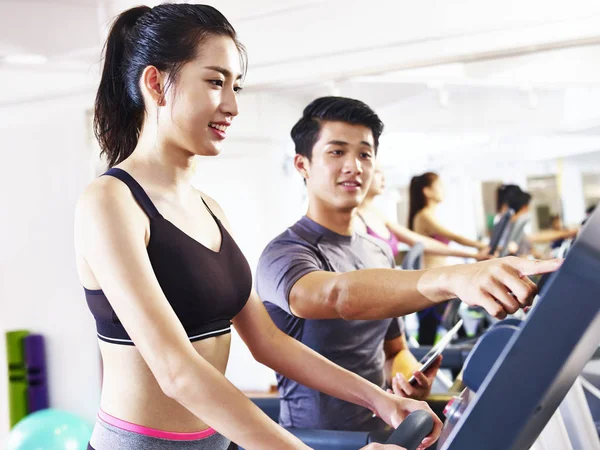 Joven asiático mujer ejercitando en cinta de correr — Foto de Stock