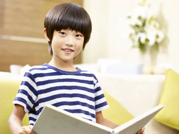 Asian little boy reading book at home — Stock Photo, Image