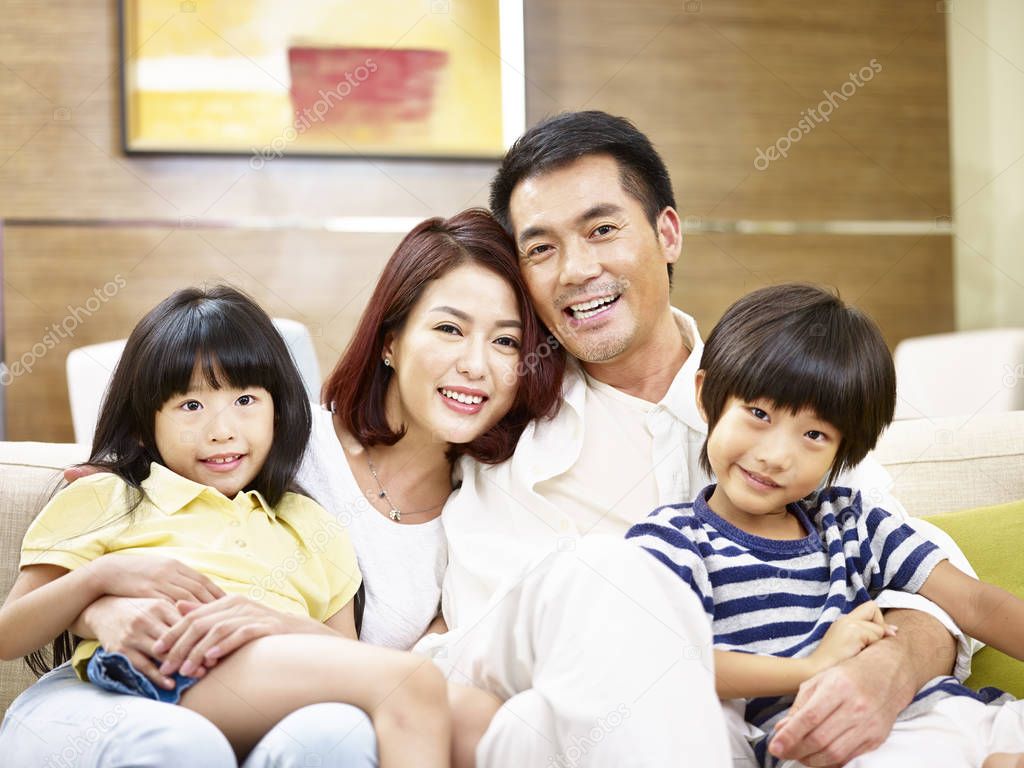 portrait of a happy asian family with two children