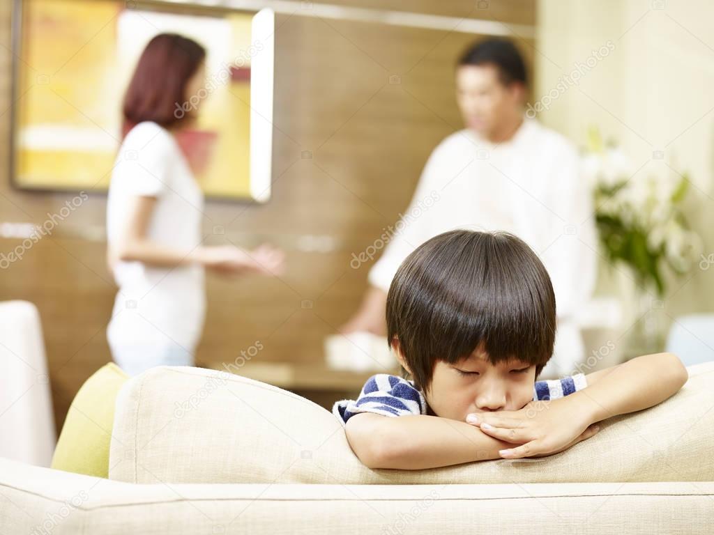 unhappy child and quarreling parents