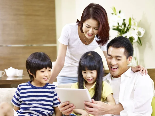 Famiglia asiatica con due bambini che utilizzano tablet digitale insieme — Foto Stock