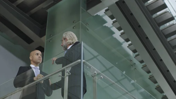 Ejecutivos corporativos discutiendo negocios en edificio moderno — Foto de Stock