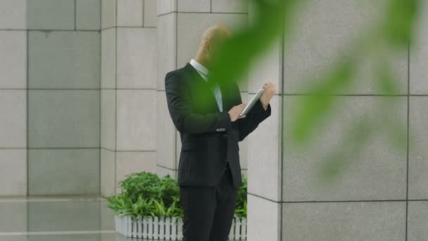 Young Business Man Standing Next Building Columns Using Digital Tablet — Stock Video