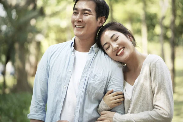 young asian couple relaxing in park