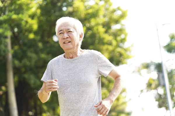 Asian old man jogging in park — Stock Photo, Image