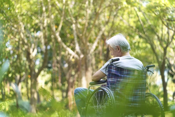 Asian senior man sitting in wheelchair — Stock Photo, Image