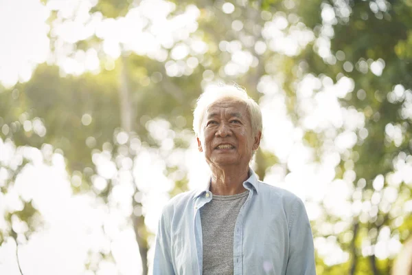 outdoor portrait of asian senior man