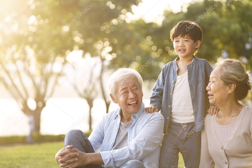 asian grandparents enjoying good time with grandson