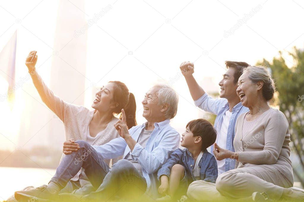 happy asian family taking a selfie