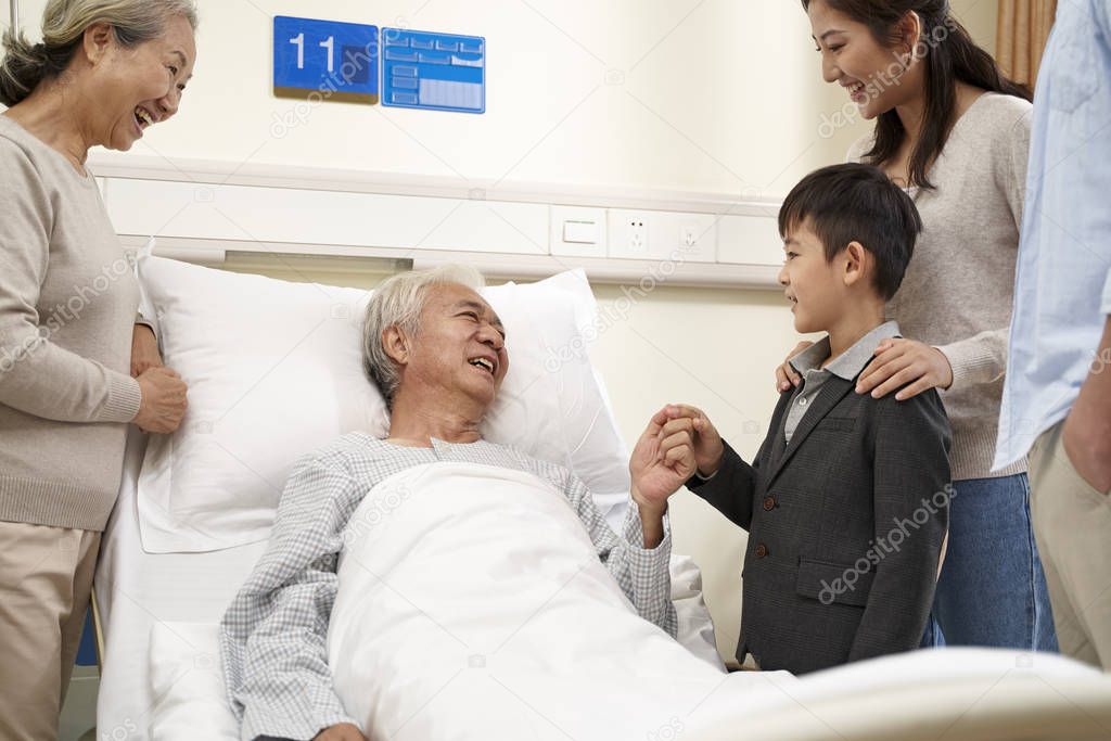 asian couple and son visiting grandfather and grandmother in hos