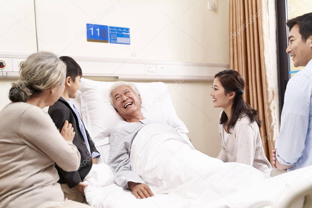 asian couple and son visiting grandfather and grandmother in hos