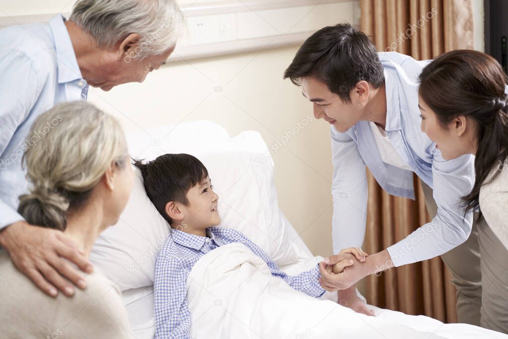 asian parents and grandparents visiting hospitalized child