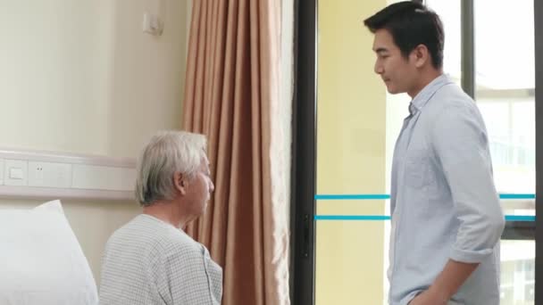 Asian Adult Son Visiting Talking Senior Father Hospital Ward — Stock Video