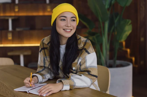 Korean student studying, learning language, exam preparation at library, education concept. Asian woman planning start up project, working in office. Portrait of young successful writer at workplace