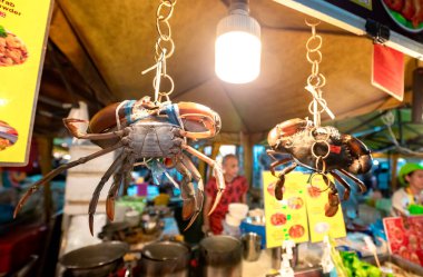 Giant Crabs Hanging by a Thread at Street Food Festival in Krabi Walking Street, Thailand clipart