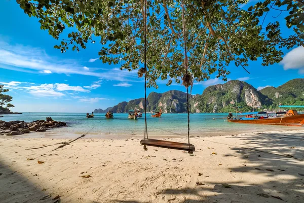 Swing hang from coconut tree over beach, Phi Phi Island, Thailand;