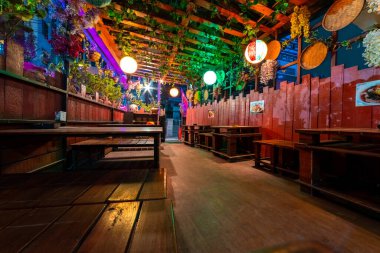 Geceleri bitki ve Çin fenerleriyle süslenmiş bir kafe restoranının içinde.