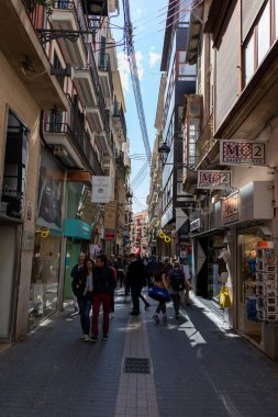 Palma, Mallorca - April 10, 2019: many tourists walking in a old thin street in town of Palma de Malorca, Spain