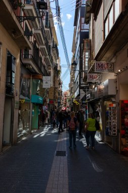 Palma, Mallorca - April 10, 2019: many tourists walking in a old thin street in town of Palma de Malorca, Spain
