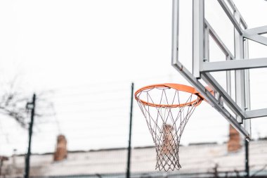 Sokak sporları sahasında turuncu bir basketbol ringi. Alt manzara. Hava bulutlu. makro fotoğraf. arkaplan
