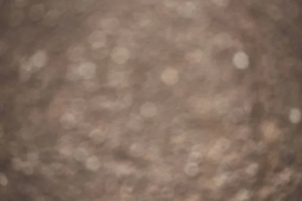 A blurred background of brown. texture of wet asphalt. soft side. circles are drawn with light