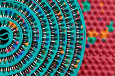 Bükülmüş yeşil masaj bandıyla, metal çivili, iğneli birleşik çerçeve. Makro fotoğraf. Reklam, tematik ve konu çekimi. Rahatlama ve sağlık için..