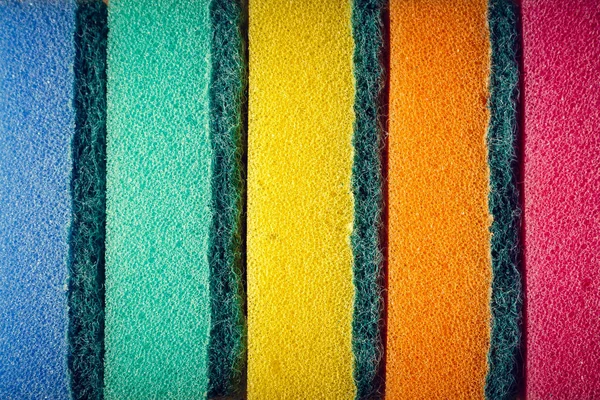 Esponjas multicoloridas em uma fileira. Material de microfibra. Para lavar louça . — Fotografia de Stock