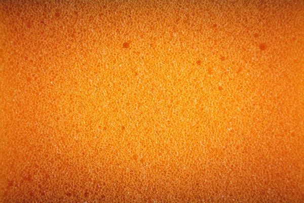 Esponja naranja hecha de material de microfibra. Textura, fondo. En aumento —  Fotos de Stock