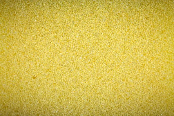 Esponja amarilla hecha de material de microfibra. Textura, fondo. En aumento —  Fotos de Stock