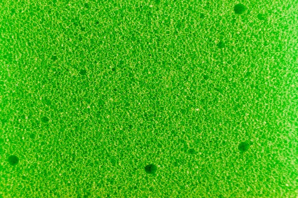 Esponja verde hecha de material de microfibra. Textura, fondo. En aumento —  Fotos de Stock
