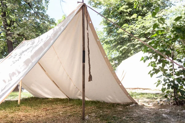 Military tent made of white matter in the field. On the ground