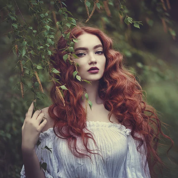 Sensual menina ruiva em um vestido branco com ombros nus perto do vidoeiro . — Fotografia de Stock