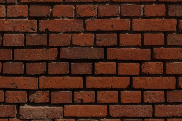 Una pared de ladrillo como fondo — Foto de Stock