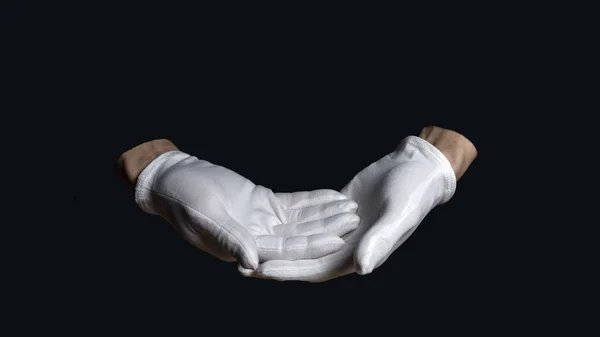 Manos en guantes blancos sobre fondo negro. una mano descansa sobre la otra haciendo una señal de bendición sobre un fondo negro — Foto de Stock