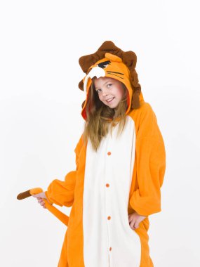 pretty blonde girl in cozy lion costume posing in front of white wall
