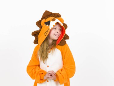 pretty blonde girl in cozy lion costume posing in front of white wall