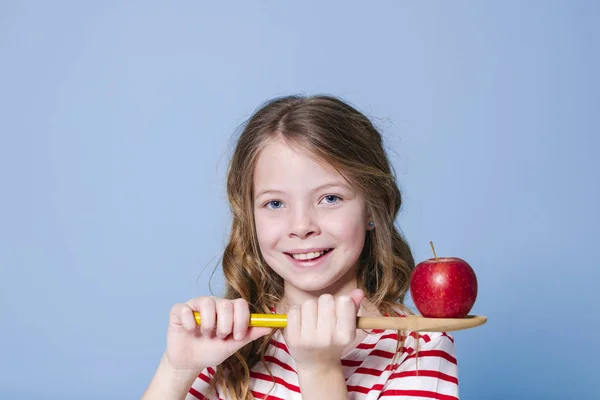 Beautiful Young Girl Holding Wooden Spoon Red Apple Front Blue — Stok fotoğraf