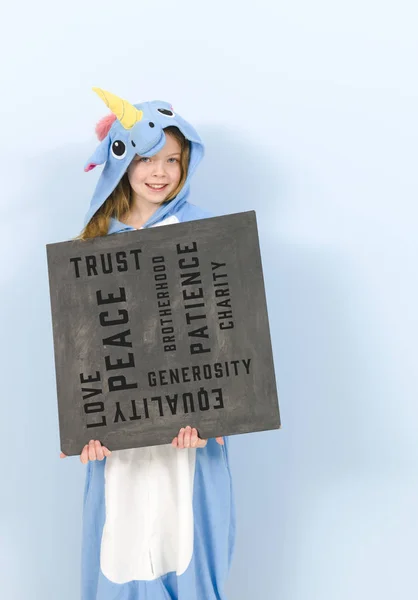 Girl Cozy Blue Unicorn Costume Holding Blackboard Written Words Posing — Stockfoto