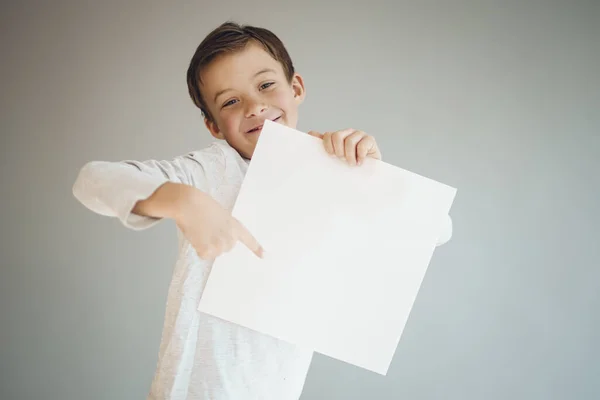 Cool Young Boy Holding White Empty Sheet Front Grey Background — Stock Photo, Image