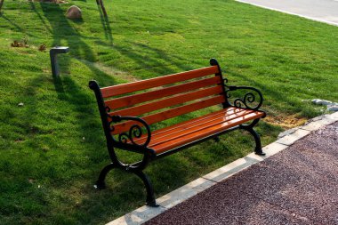 Wooden bench in the city park clipart