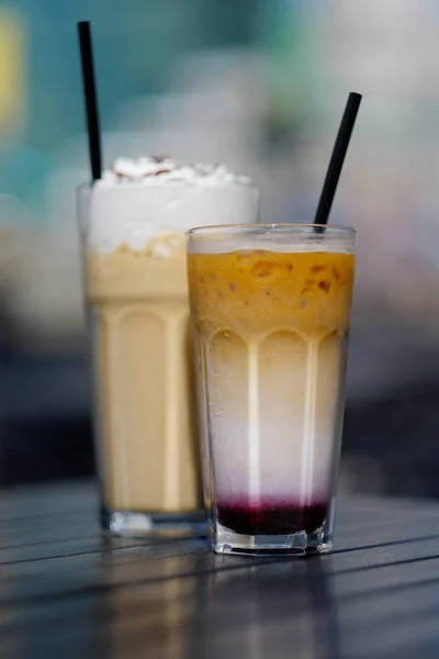 Latte with whipped cream and milky berry cocktail with blackberries and caramel — Stock Photo, Image