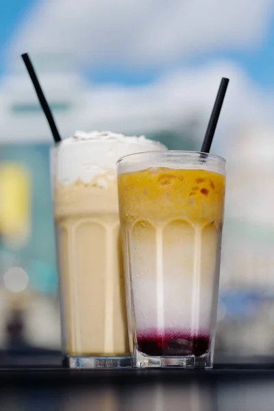 Latte with whipped cream and milky berry cocktail with blackberries and caramel — Stock Photo, Image