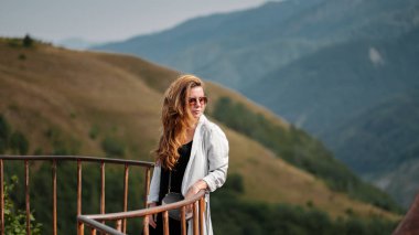 Genç kadının Gudauri, Gürcistan'daki Kafkas dağlarının görünümü.