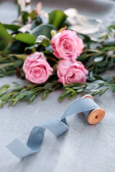 Pink roses, eucalyptus and coil with ribbon — Stock Photo, Image