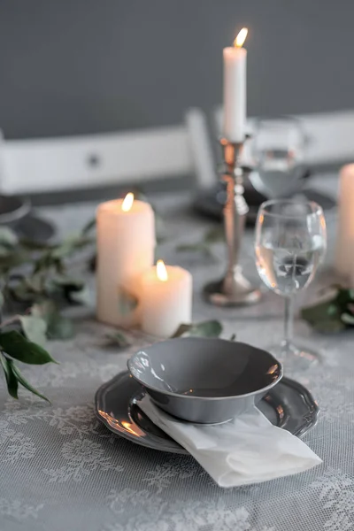 Весільна або святкова обстановка столу. Тарілки, келихи для вина, свічки та столові прибори — стокове фото