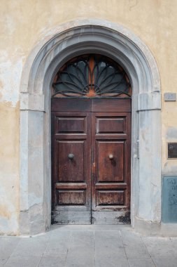 Ancient wooden door in Italy clipart