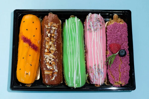 set of sweet eclairs in box, close view