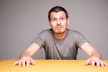 Funny man sitting at table